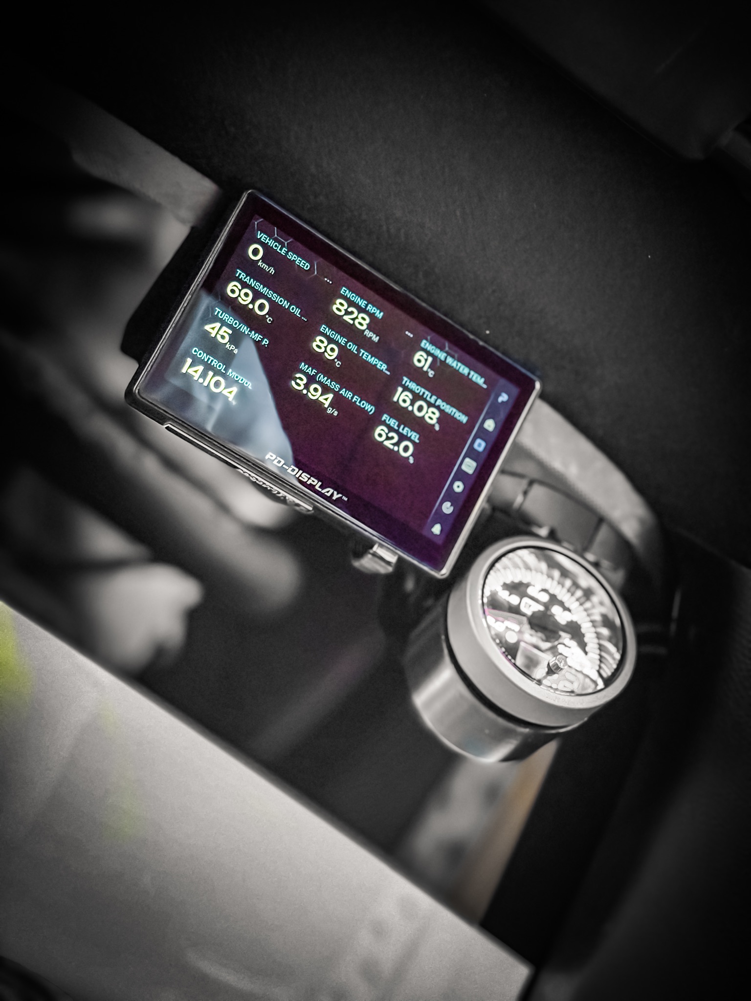 Close-up of PD-Display showing vehicle readings beside an analogue gauge