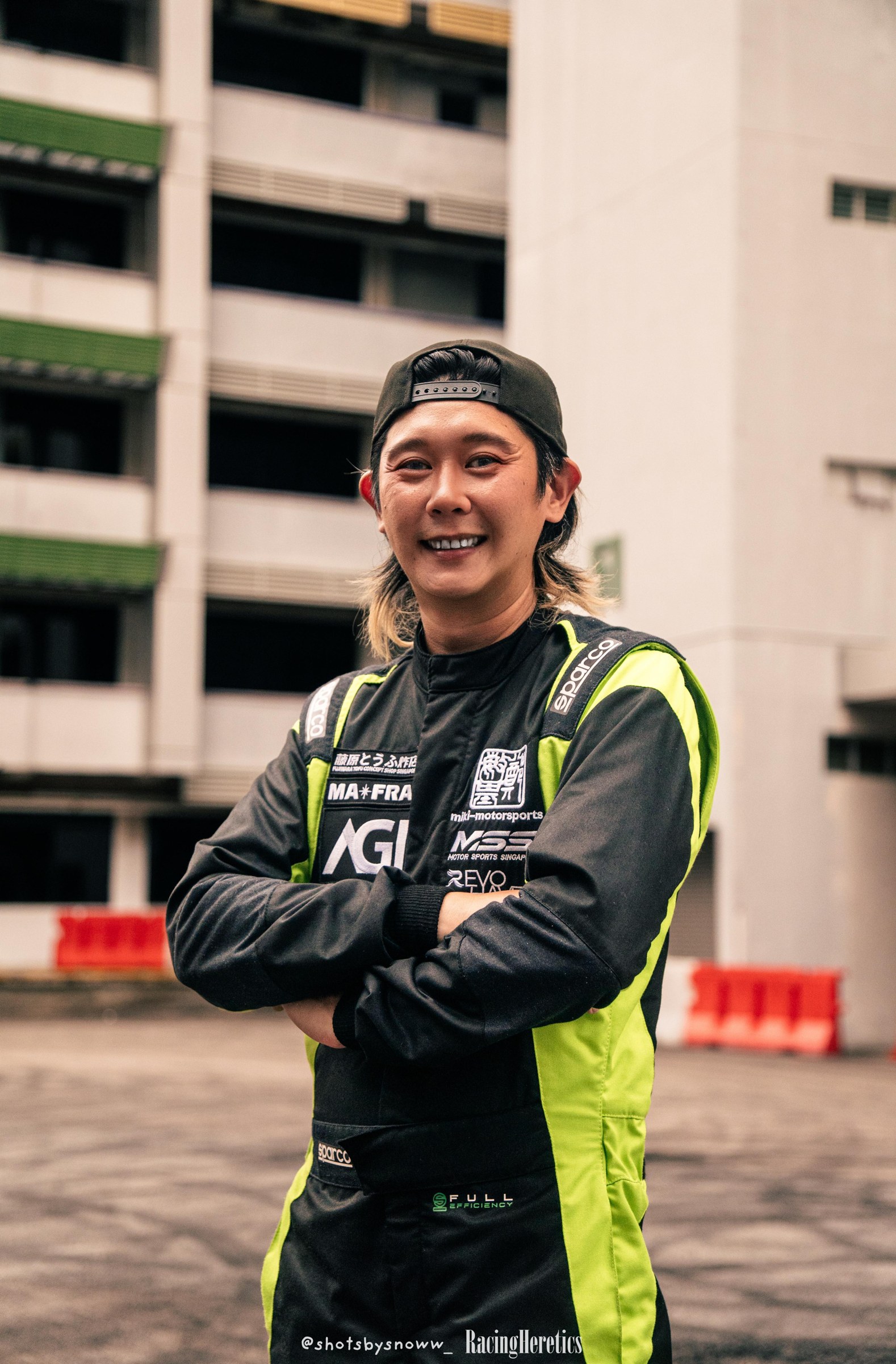 Chawin Tan in a black and lime racing suit